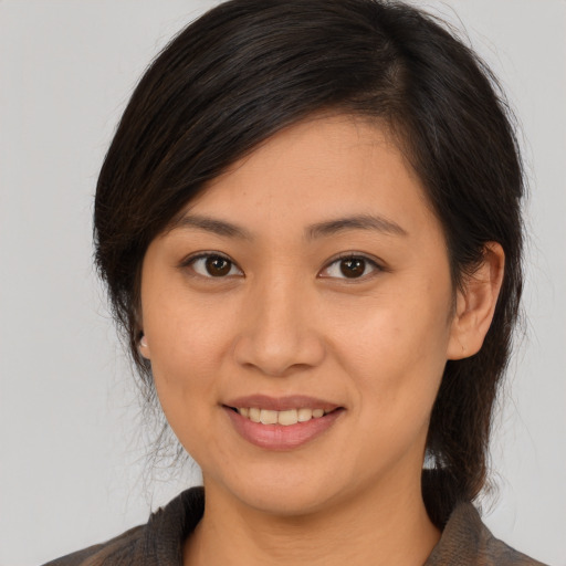 Joyful asian young-adult female with medium  brown hair and brown eyes