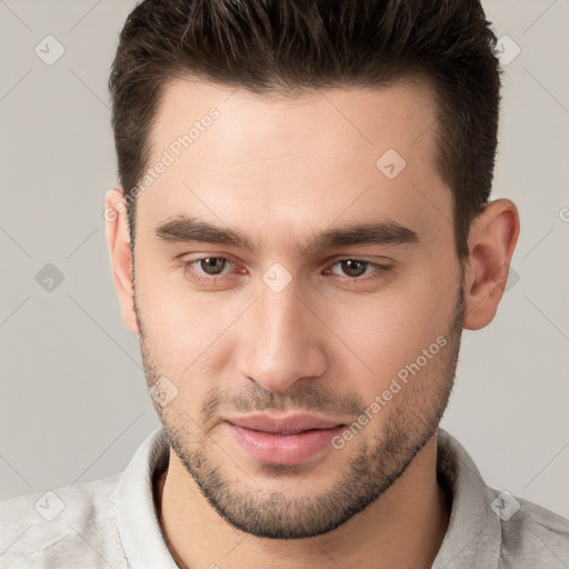 Joyful white young-adult male with short  brown hair and brown eyes