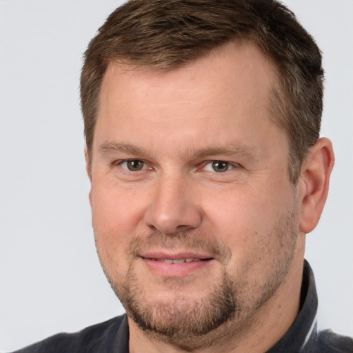 Joyful white adult male with short  brown hair and brown eyes