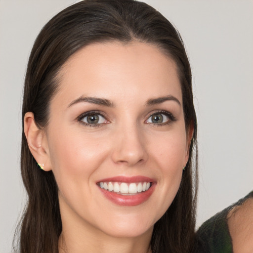 Joyful white young-adult female with long  brown hair and brown eyes