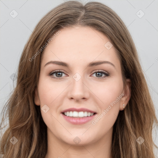 Joyful white young-adult female with long  brown hair and green eyes