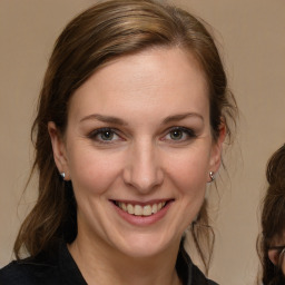 Joyful white adult female with long  brown hair and brown eyes