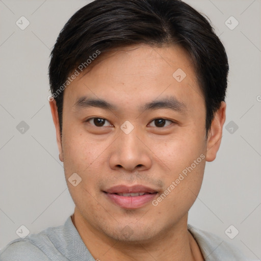 Joyful asian young-adult male with short  black hair and brown eyes