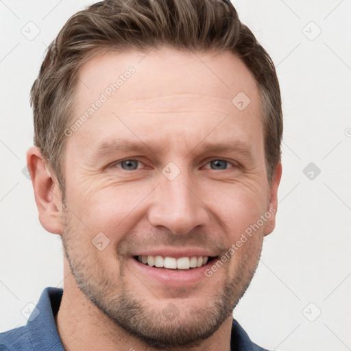 Joyful white adult male with short  brown hair and grey eyes