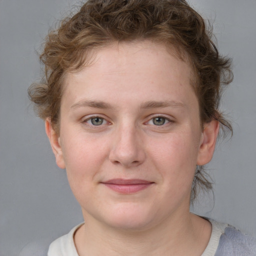 Joyful white young-adult female with short  brown hair and blue eyes