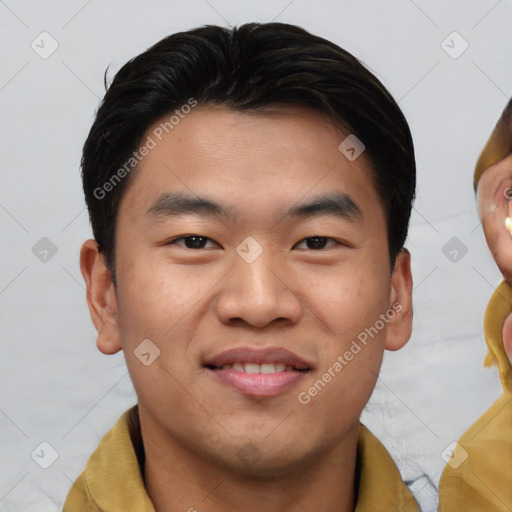 Joyful asian young-adult male with short  black hair and brown eyes