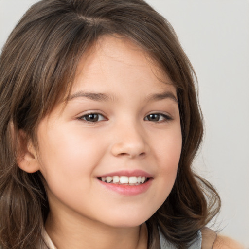 Joyful white child female with long  brown hair and brown eyes