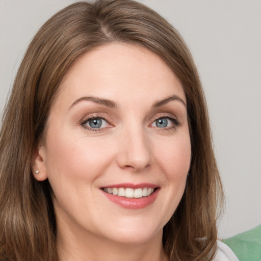 Joyful white young-adult female with medium  brown hair and blue eyes