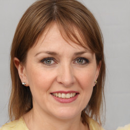 Joyful white adult female with medium  brown hair and brown eyes