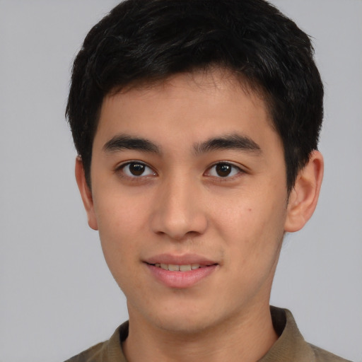 Joyful asian young-adult male with short  brown hair and brown eyes