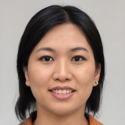 Joyful asian young-adult female with medium  black hair and brown eyes