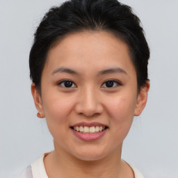 Joyful asian young-adult female with short  brown hair and brown eyes