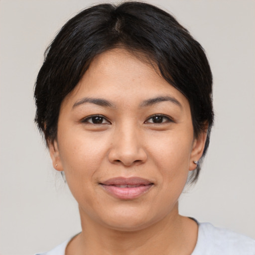 Joyful asian young-adult female with medium  brown hair and brown eyes