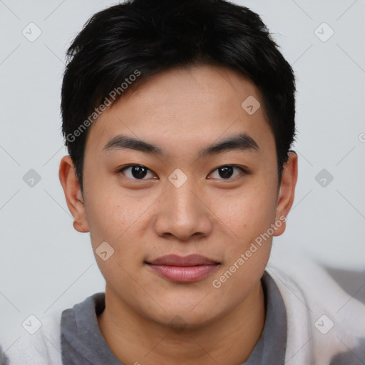 Joyful asian young-adult male with short  black hair and brown eyes