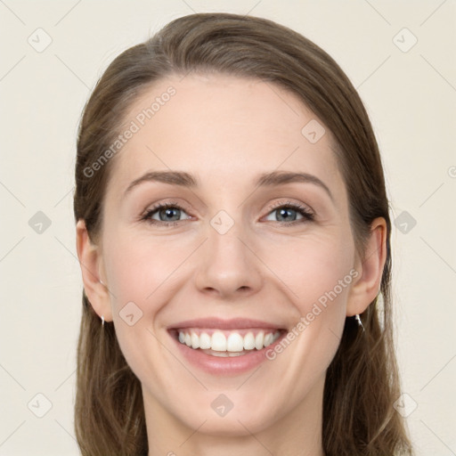 Joyful white young-adult female with long  brown hair and green eyes