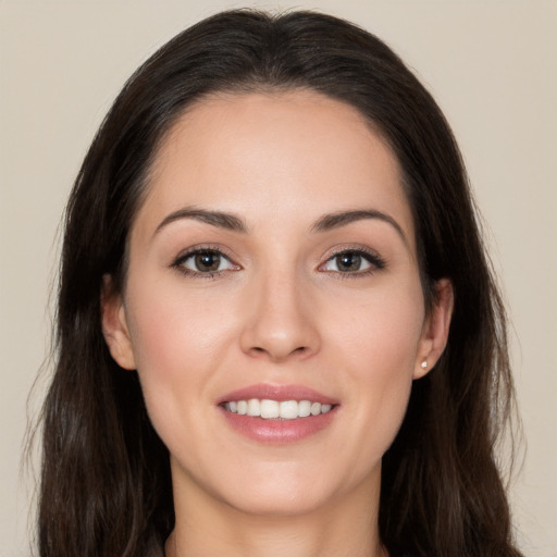 Joyful white young-adult female with long  brown hair and brown eyes