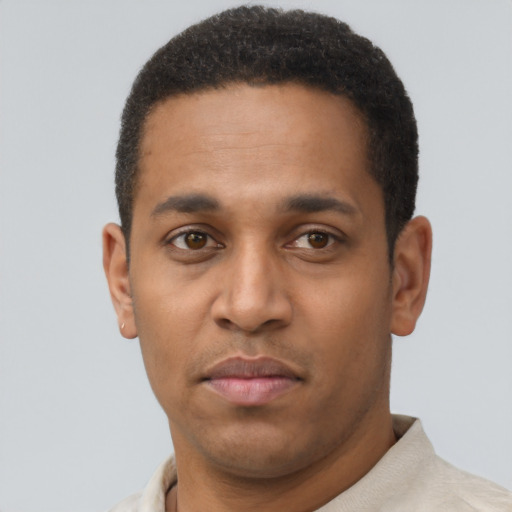 Joyful latino young-adult male with short  brown hair and brown eyes