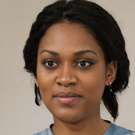 Joyful black young-adult female with medium  black hair and brown eyes