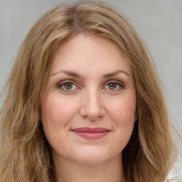 Joyful white young-adult female with long  brown hair and green eyes