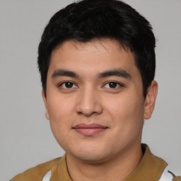 Joyful asian young-adult male with short  black hair and brown eyes