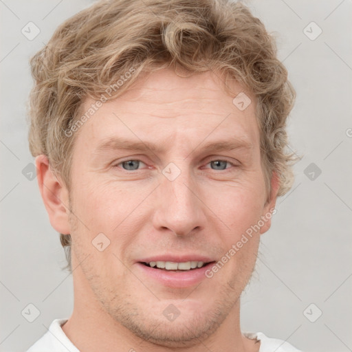 Joyful white adult male with short  brown hair and grey eyes