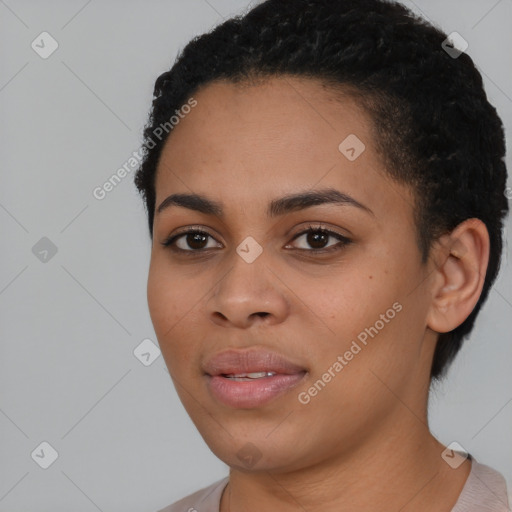 Joyful black young-adult female with short  black hair and brown eyes