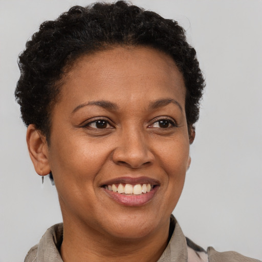 Joyful latino adult female with short  brown hair and brown eyes