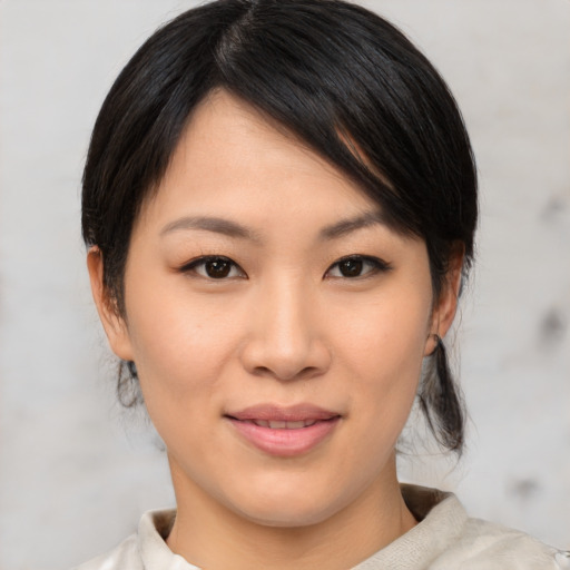 Joyful asian young-adult female with medium  brown hair and brown eyes