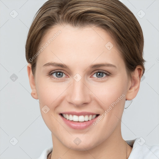 Joyful white young-adult female with short  brown hair and grey eyes