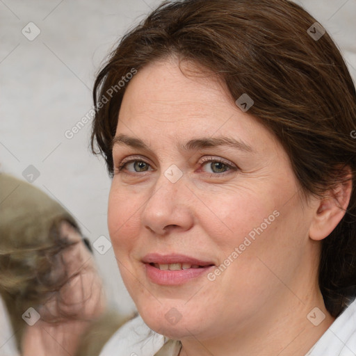 Joyful white adult female with medium  brown hair and blue eyes