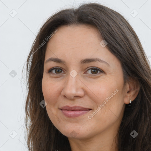 Joyful white adult female with long  brown hair and brown eyes