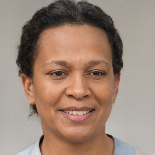 Joyful latino adult female with short  brown hair and brown eyes