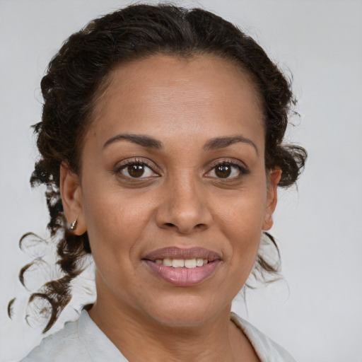 Joyful black adult female with medium  brown hair and brown eyes