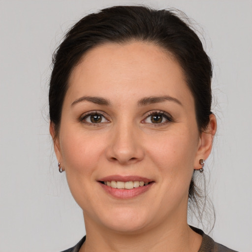 Joyful white young-adult female with medium  brown hair and brown eyes