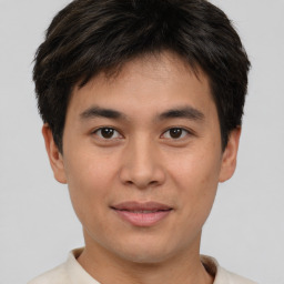 Joyful asian young-adult male with short  brown hair and brown eyes