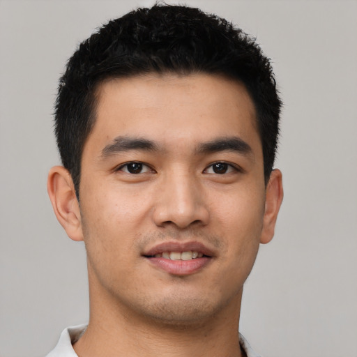 Joyful asian young-adult male with short  black hair and brown eyes