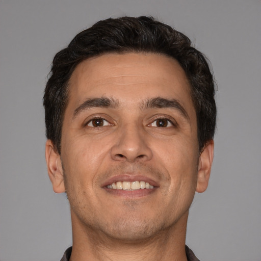 Joyful white adult male with short  brown hair and brown eyes