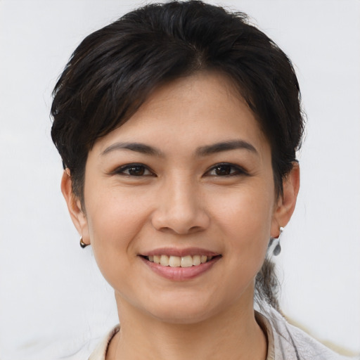 Joyful asian young-adult female with short  brown hair and brown eyes