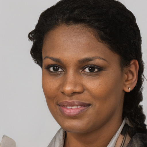 Joyful black young-adult female with short  brown hair and brown eyes