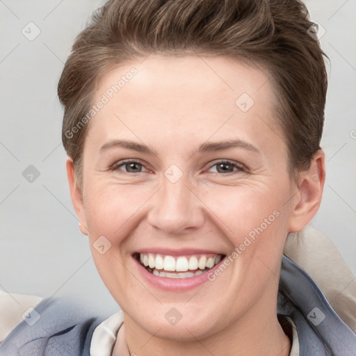 Joyful white young-adult female with short  brown hair and grey eyes