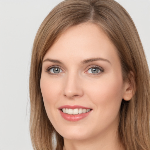 Joyful white young-adult female with long  brown hair and grey eyes