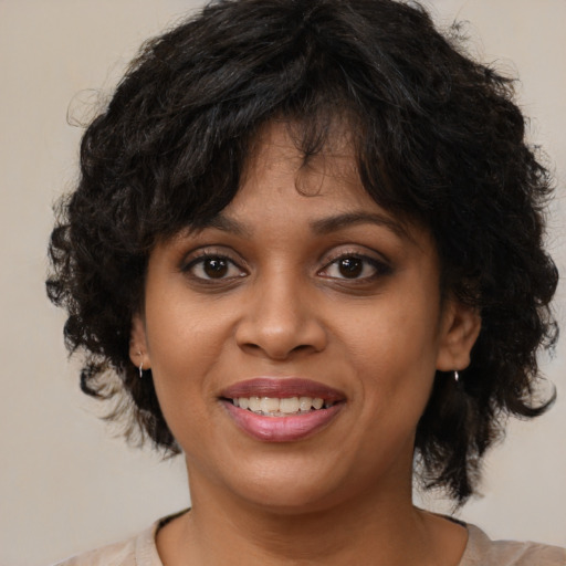 Joyful black young-adult female with medium  brown hair and brown eyes