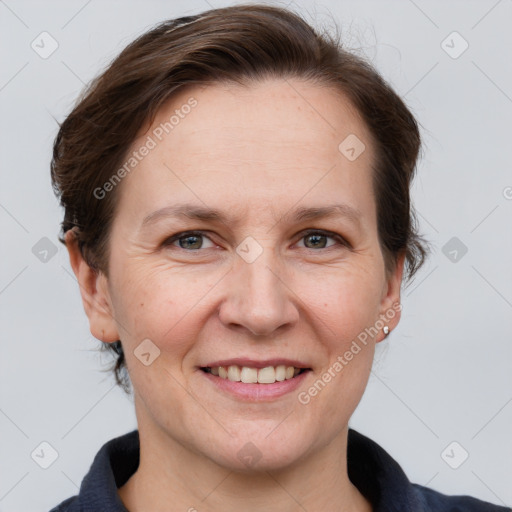 Joyful white adult female with short  brown hair and grey eyes