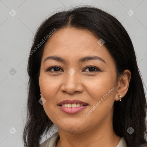 Joyful asian adult female with long  brown hair and brown eyes