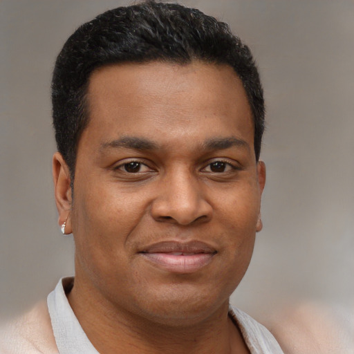 Joyful black young-adult male with short  brown hair and brown eyes