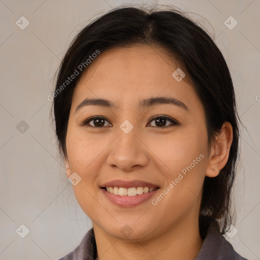 Joyful latino young-adult female with medium  brown hair and brown eyes