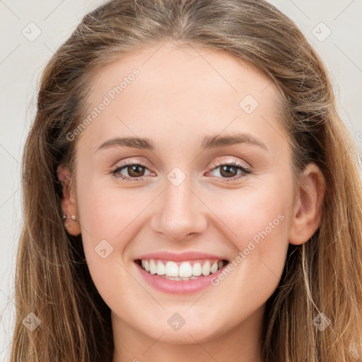 Joyful white young-adult female with long  brown hair and green eyes