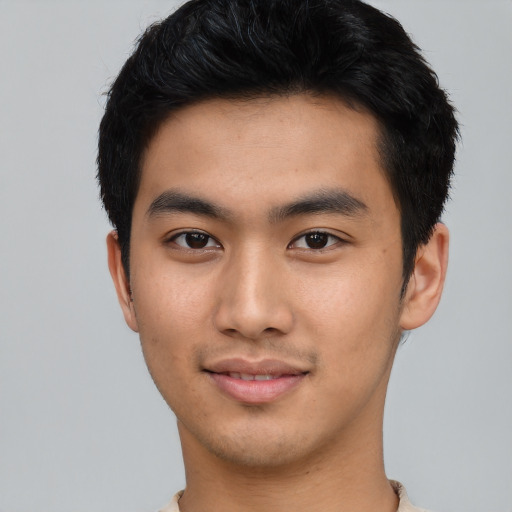 Joyful asian young-adult male with short  black hair and brown eyes