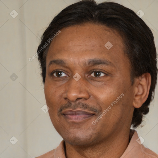 Joyful black adult male with short  brown hair and brown eyes