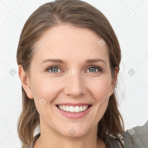 Joyful white young-adult female with long  brown hair and grey eyes